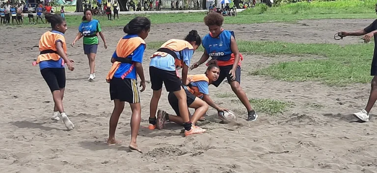 School children playing rugby league.