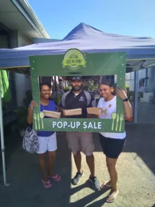 Abus Na Kumu, staff and customers pose for a picture. 
